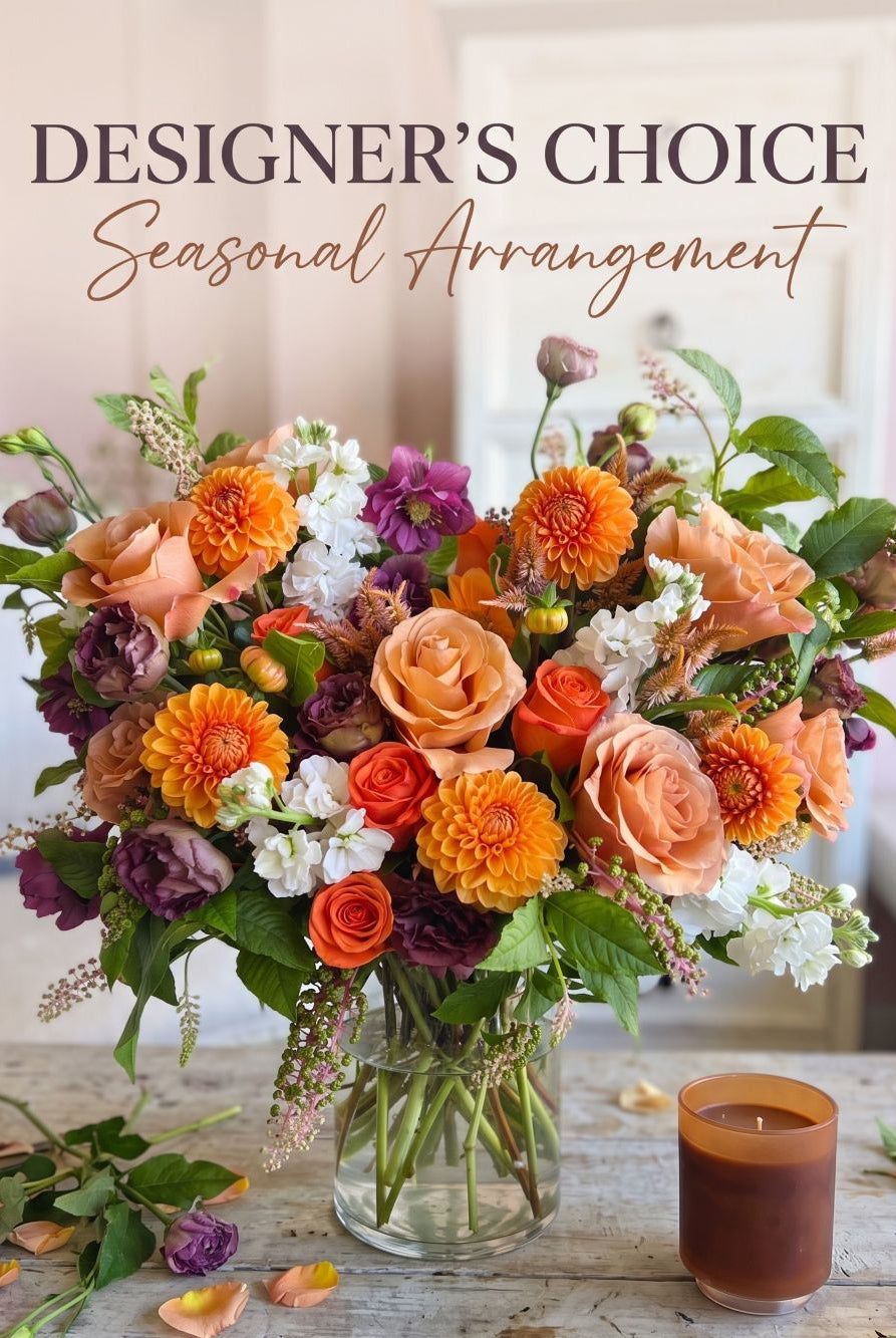 Designer's Choice Seasonal Arrangement: autumn bouquet of peach roses, orange dahlias, burgundy lisianthus and white stock in a glass vase