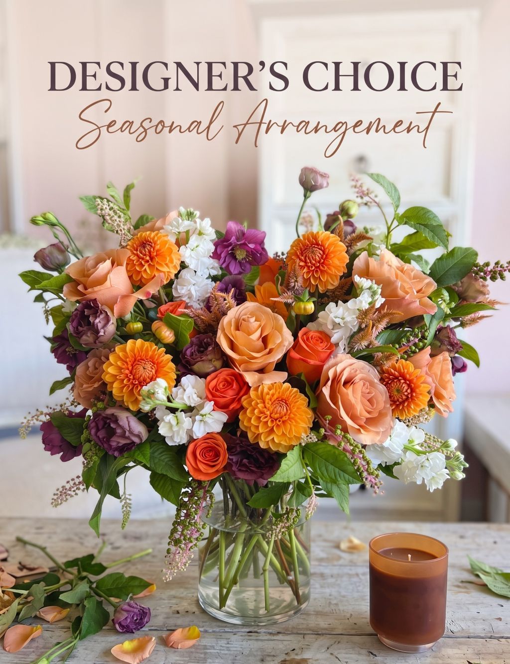 Designer's Choice Seasonal Arrangement: autumn bouquet of peach roses, orange dahlias, burgundy lisianthus and white stock in a glass vase