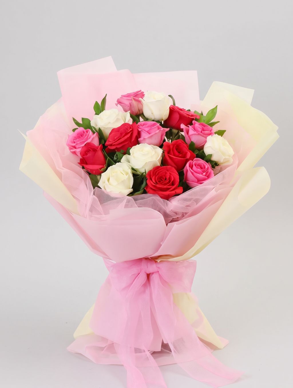 Sweet Love Roses Bouquet of red, pink and white roses with greenery wrapped in pink and cream paper with pink tulle and a tulle bow