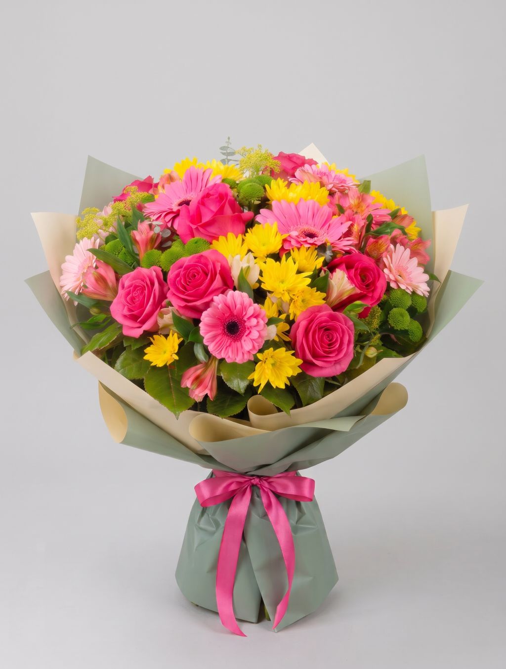 Vibrant Summer Bouquet of hot pink roses, pink gerbera daisies, yellow daisy mums, pink alstroemeria and green button mums wrapped in sage green and cream paper with a hot pink ribbon