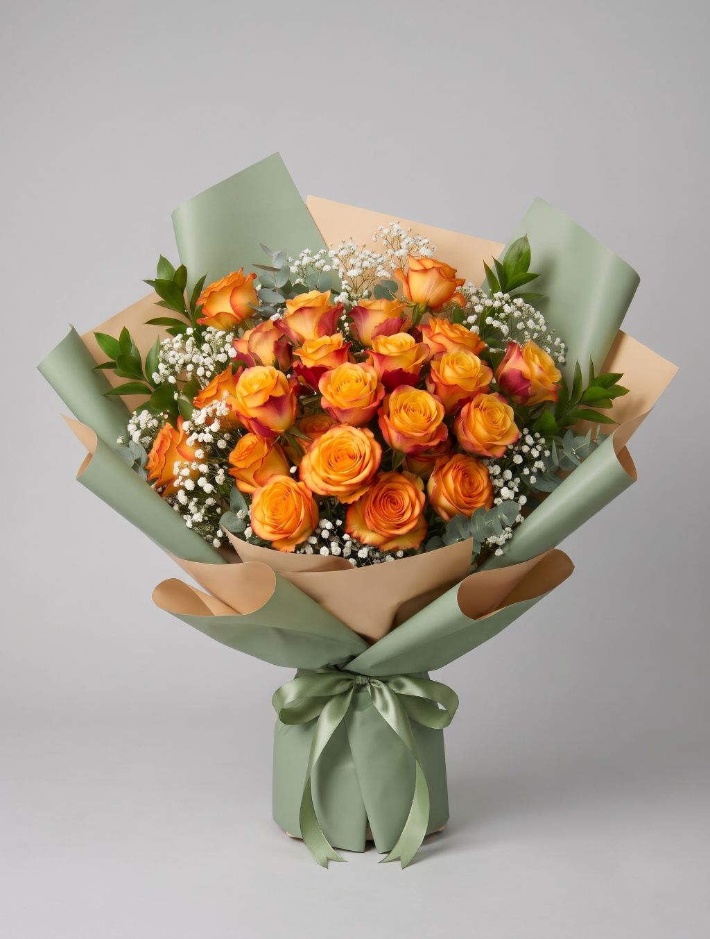 18 Bi-Colour Orange Roses Bouquet of eighteen orange Silantoi roses with red-tipped petals, baby’s breath, eucalyptus and greenery wrapped in sage green and tan paper with a sage ribbon