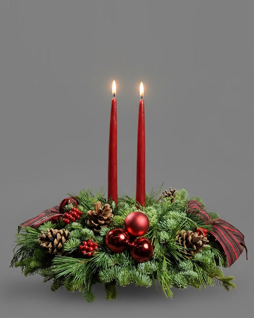 Classic Holiday Centerpiece with reds and evergreen on a traditional Christmas dinner table.