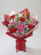 Red Roses & Pink Lilies Bouquet of red roses and pink lilies with greenery, hand-tied and gift-wrapped with a ribbon